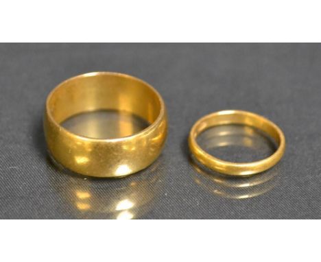 A large 22ct gold wedding band, size Y, Birmingham 1945;  another , size K, 15.3g gross (2)