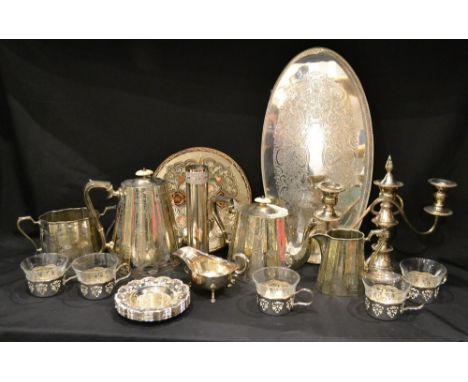 A late Victorian electroplated four piece tea service; a two branch table candelabra; a set of coffee cups; oval tray; other 