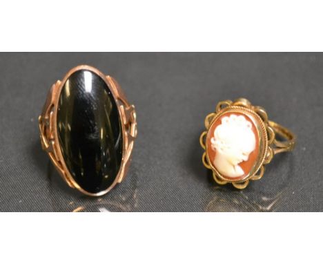 An Art Nouveau 9ct rose gold and black onyx oval dress ring, Archibald Knox Style open cast shank, size R, 7.7g gross;  anoth