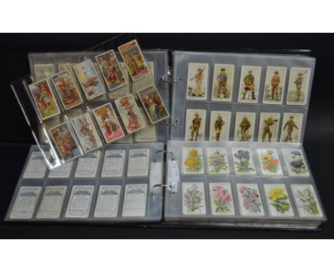 Cigarette Cards - two albums of cigarette cards including Wills Famous Inventions, Gallaher's Army Badges, etc