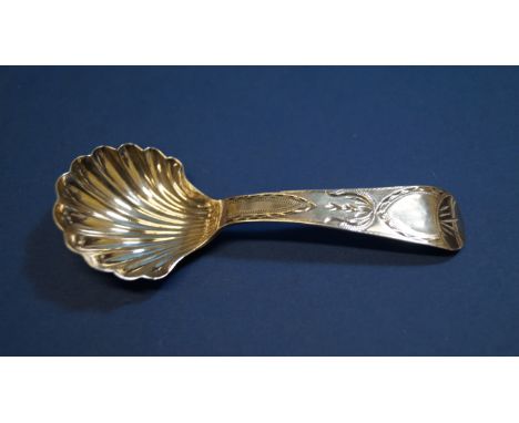An early 19th century silver caddy spoon, probably by Thomas Wheatley of Newcastle, having shell shaped bowl and brightcut de