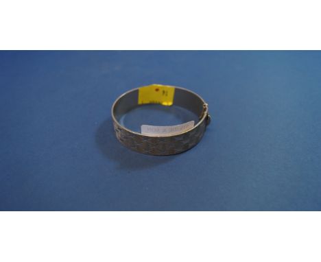 A silver bangle, marked 'Nymph' and 'Brit.Patent', with brightcut star decoration.
