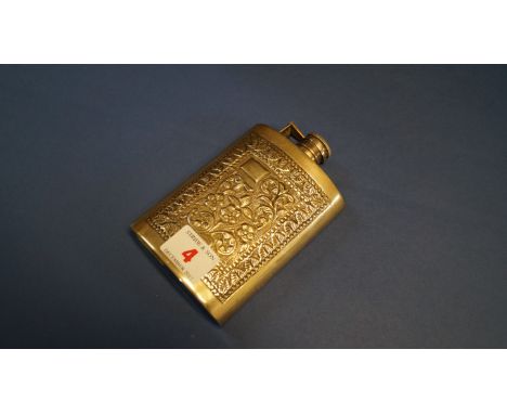 A metal hip flask having chased decoration, 13cm.