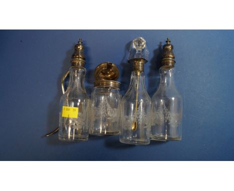 Four Victorian silver mounted condiment bottles; together with a Victorian silver condiment spoon, by F.H, London 1874.