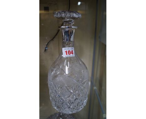 A silver mounted cut glass decanter and stopper.