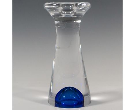 A clear abstract form candlestick holder accented with a navy-blue glass bubble at the bottom. Kosta Boda and artist's name e