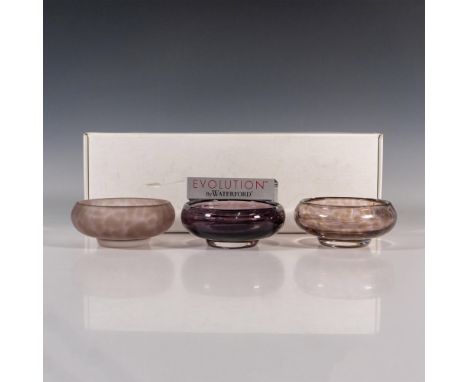 A set of 3 small squatted decorative accent bowls. Though each piece are purple with brown spots, each bowl has an unique des