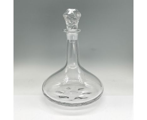 Elegant clear crystal decanter with etched stopper. Orrefors etched mark. Dimensions: 7.5"H x 11.25" diaManufacturer: Orrefor