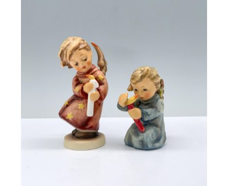 One blonde angel in a red robe adorned with stars, delicately holding a candle, alongside another angel dressed in a blue rob
