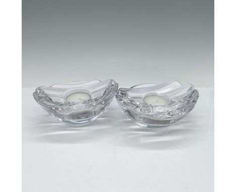 Crafted from clear crystal with a faceted top to catch the light and a curved base. Orrefors sticker attached. This item has 