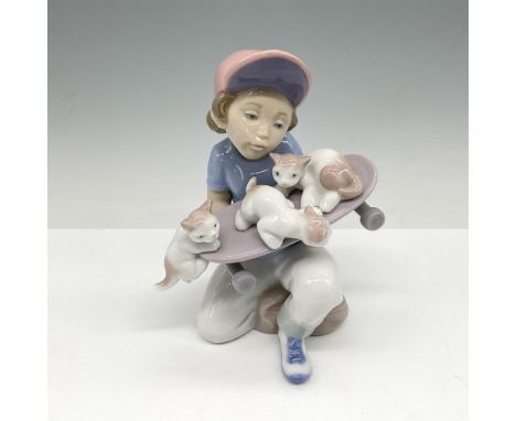 Glossy 1994 event figural of skateboarder holding his board full of kittens. Lladro backstamp. Artist: Salvador DebonIssued: 