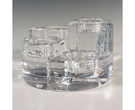 A set of 4 clear votive candle holders in various sized wedge pieces. Together the pieces form a circle. Orrefors marked. Tal