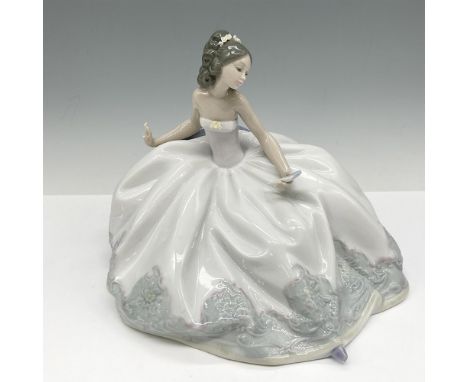 Glossy figural in beautiful gown sitting on settee holding her fan. Colored in white, grey and pink. Lladro backstamp. Artist