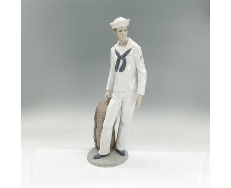 Glazed porcelain figure of a man in a sailor suit holding his luggage. Lladro backstamp. This item has its original box: 9"L 