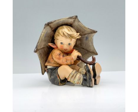 A young village boy in an orange and brown jacket, seated and holding a brown umbrella over his head. Goebel Hummel backstamp