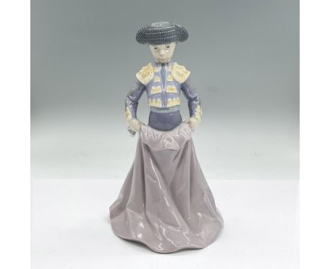 Glazed porcelain figure of a boy dressed in a classic matador outfit standing holding a blanket. Lladro backstamp. This item 