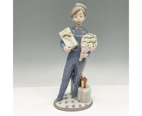 Glossy figural in hotel staff attire holding gifts to be delivered. Lladro backstamp. This item has its original box: 7.5"L x