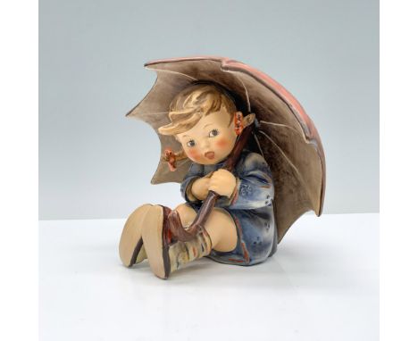 A young blonde girl in a blue raincoat, holding a red umbrella over her head. Goebel Hummel backstamp. Dimensions: 5"L x 4.5"