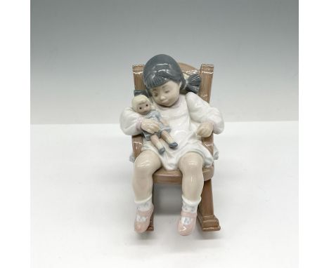 Adorable glossy figural in rocking chair with doll. Lladro backstamp. Artist: Jose PucheIssued: 1987 - 2004Dimensions: 3"L x 