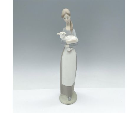 Matte finish figure of a girl holding an adorable lamb in her arms. Lladro backstamp. Artist: Fulgencio GarciaIssued: 1969-19