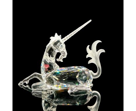 Brilliant cut crystal figure of a majestic unicorn lying down with frosted horn, tail and mane. Swarovski etched mark. The Un