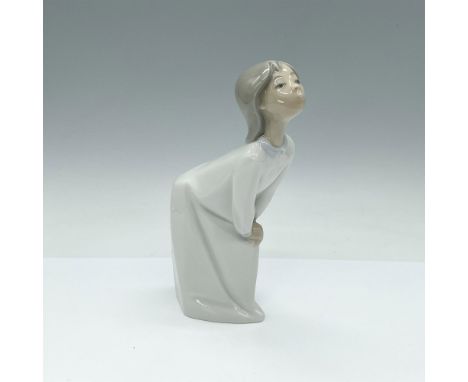 This glossy figurine depicts a girl in simple white gown waiting for a kiss. Nao backstamp. Dimensions: 4.5"L x 2"W x 7"HManu