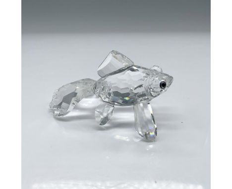 Depicts a clear crystal telescope fish standing on its fins with Sahara colored eyes. This item has its original box which me