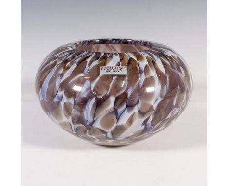 A round squatted vessel with white and brown spots. Evolution by Waterford sticker on the side and engraved marking on the un
