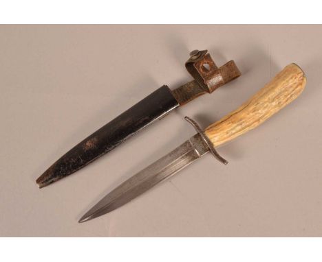 A WWI German Boot/Fighting knife by Union, having 14.5cm long double edged blade, with makers stamp to the base, with S shape