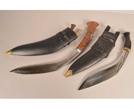 An interesting kukri knife, having an extra long grip, together with another kukri, having decorative blade, both with sheath