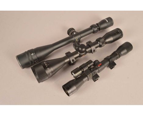 A group of three scopes, including a Tasco WC624X4OS, a Gamo Pest Control VP4X32WR with laser and light, and a Gamo Matrik MD