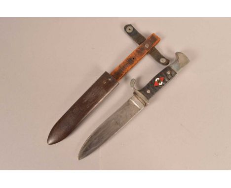 A Hitler Youth Knife, with 13.5cm long single edged blade, with the naming rubbed off, with cross hatched grip, with applied 