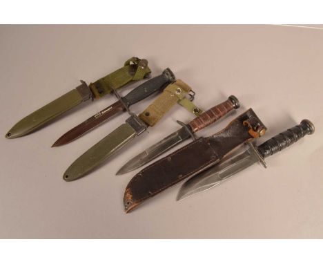 A US Kabar fighting knife by Camillus, with leather sheath, together with a US M3 with scabbard (AF), plus a US M7 with Solin