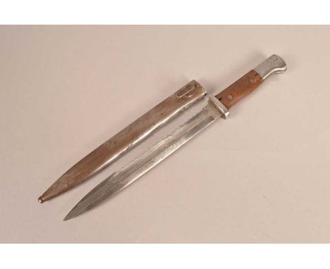 A WWI German Sawback Bayonet by Gottlieb, having 25cm long blade, with small stamp to the pommel, complete with scabbard, AF 