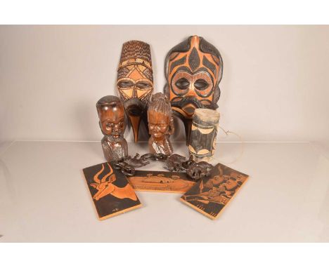 A selection of Tourist Tribal Artiwork and figures, to include busts of a male and female, a small drum, three wall hanger bo