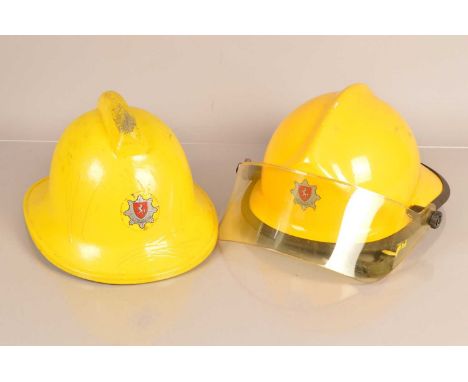 Two 1990s Fire Fighters helmets, to include a model BS1 with visor, the other with a high comb, dated 1989, both worn by John