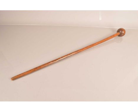 A wooden Knobkerrie, having a 7cm diameter knob, with 82cm long shaft, split to knob