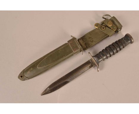 A US M3 Combat/Fighting knife by Camillus, having makers name to the cross guard, leather washer grip, complete with M8A1 sca