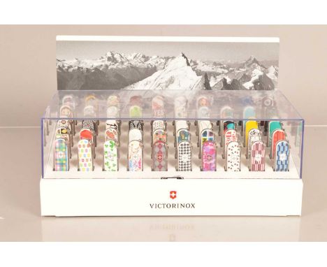 Victorinox - Classic Penknife Display, containing 50 Victorinox Classic Knives, dated 2010 to 2014, under perspex with image 