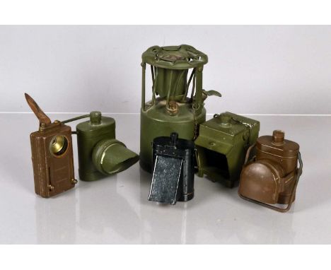 An assortment of Military Black Out Lamps, all of different design, including a Lamp Electric No.1, plus a military oil lamp 