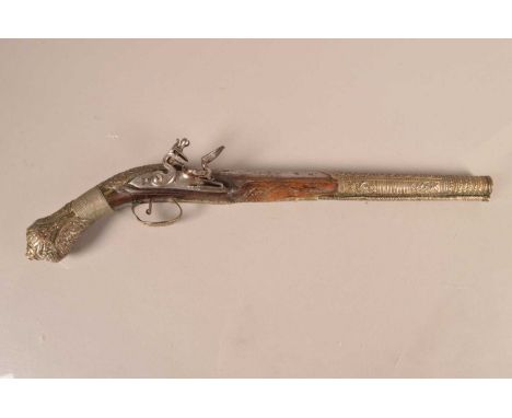 A Decorative Middle Eastern Flintlock pistol, having carved wooden stock, with applied embossed white metal decoration, 35cm 