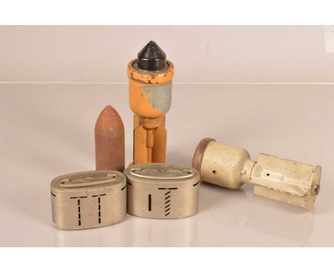 Two Inert British Anti-Tank grenades, one dated 1942, together with a broad arrow marked round, and two Barclays money boxes 