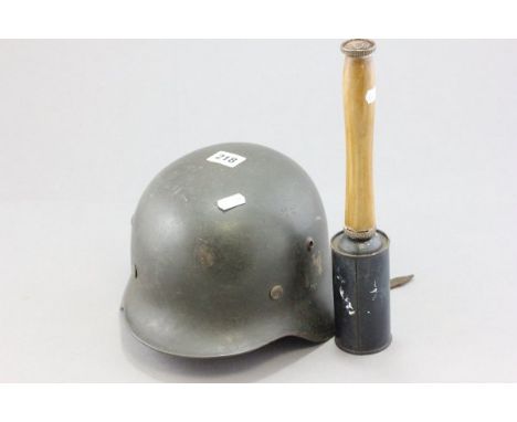 A Vintage German Military Helmet and Reproduction Potato Masher Grenade 