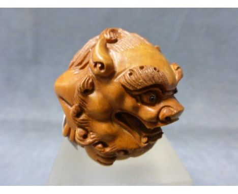 A Signed Wood Netsuke of a Dog of Foe 