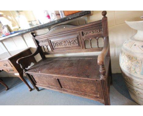 An Oak Carved Bench with cupboard below
