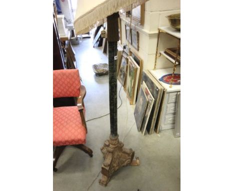 A Victorian Oak Carved Standard Lamp, the shaft covered with green velvet and tassels 