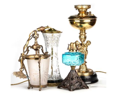 THREE TABLE LAMPS AND A PENDANT LIGHT including an adapted brass oil lamp, the stem with two putti holding an urn; another ad