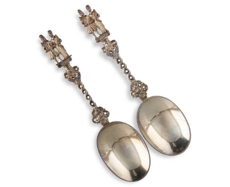 A PAIR OF VICTORIAN SILVER-GILT DECORATIVE SERVING SPOONS by Edward Pairpoint, London 1878, in the Dutch style, with oval bow
