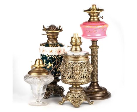 A MIXED GROUP OF OIL LAMPS including a cut glass oil lamp, with brass burner; a brass oil lamp, pierced and cast with female 