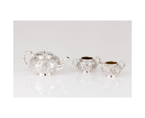 A tea setChinese silver, 19th / 20th centuryPossibly by Luen Wo (1880-1940)Teapot, milk jug and sugar bowlWith profuse relief